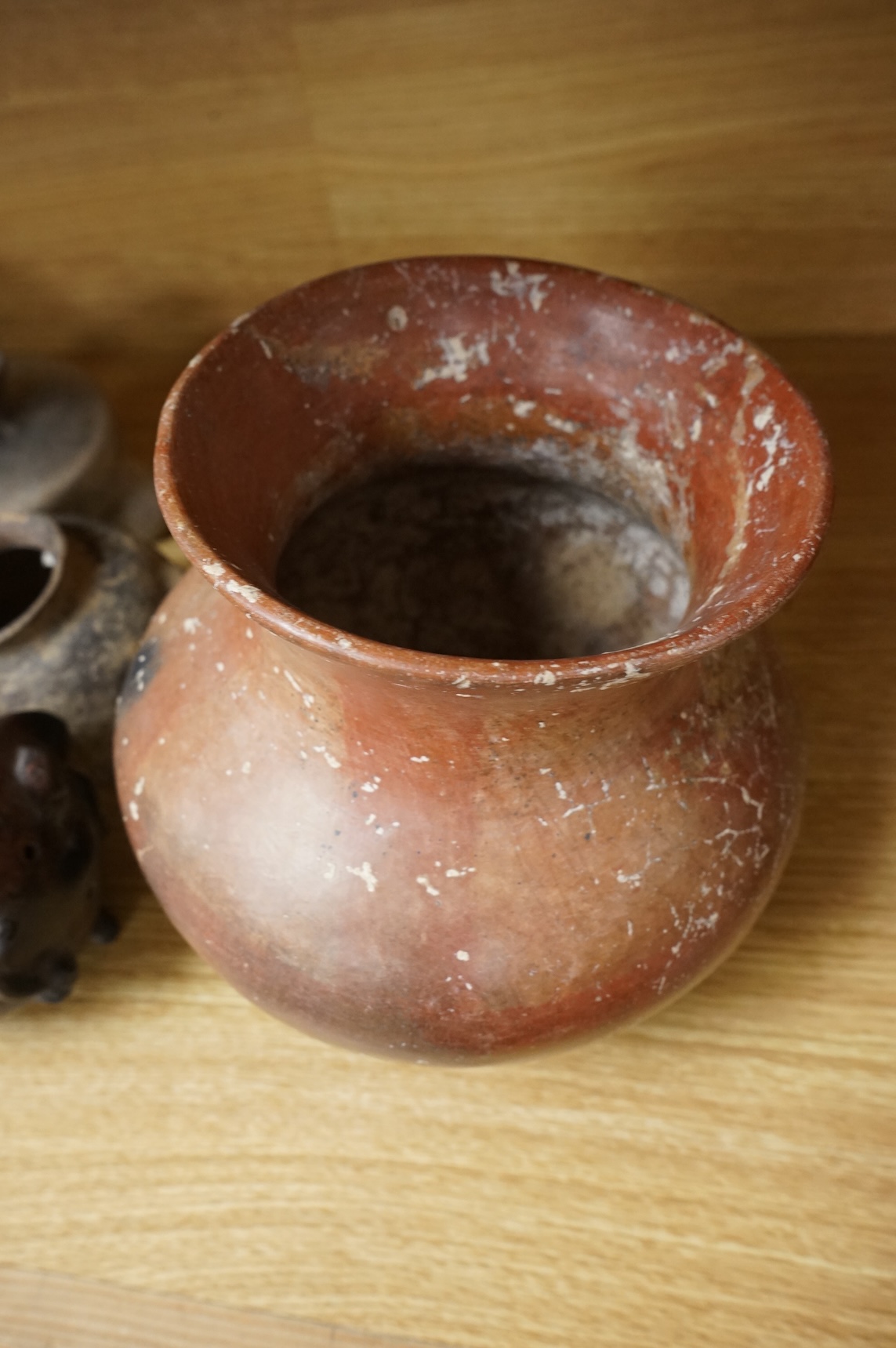 A collection of various South American vessels some in the form of grotesque heads, largest 24cm wide